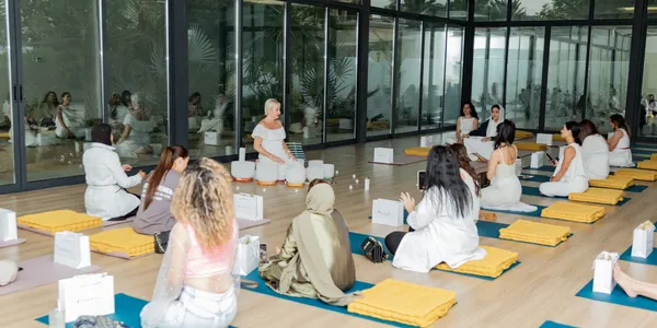 Teambuilding event with Lisa playing crystal bowls to group of people sitting on the floor